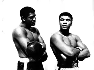 Prints of Boxers Ernie Terrell (left) and Muhammad Ali (the former Cassius Clay) stand next to each other in mock fighting poses during a pre-bout promotional event, probably in Houston, TX, 1967 In the Ring: The Art of Boxing: Terrell And Ali
