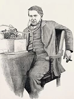 Thomas Edison at his desk, smoking a cigar