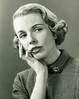 Thoughtful woman posing in studio, (B&W), portrait