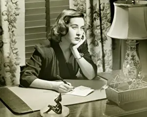 Introspection Prints: Thoughtful woman writing letter at desk, (B&W)