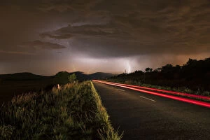 Images Dated 13th November 2009: A thunderstorm at night with lightning on a remote road in the Cradle of Humankind, Magaliesburg