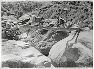 Two Tibetan Refugees Using Log as Bridge