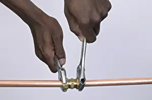 Pipe Tube Prints: Tightening nuts to a compression joint attached to copper pipes using adjustable spanners