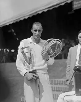Bill Tilden Holding Trophy and Tennis Rackets