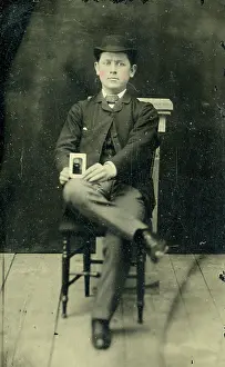 Time Captured: Vintage Art: Tinype of young man holding a photograph