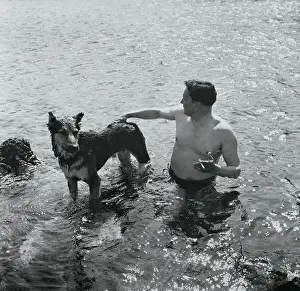 Tito Swimming With His Dog