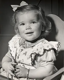 Toddler sitting in her highchair