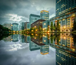 Tokyo Cityscape with skyscrapers and office buildings illuminated reflection in Hibiya
