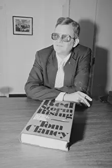 Tom Clancy with His Book Red Storm Rising