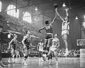 Prints of American basketball player Tom Hawkins (1936 - 2017), #20 for Los Angeles Lakers, attempts to block American basketball player Bob Pettit, #9 for St Louis Hawks (now known as Atlanta Hawks) Courtside Vibes: Stunning Basketball Prints: Tom Hawkins and Bob Pettit In Action