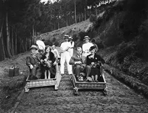 Unpaved Road Prints: Tourists Ride Guided Sledges Downhill
