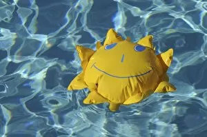 Images Dated 23rd December 2011: Toy sun floating in a swimming pool