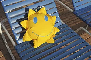 Toy sun lying on a sun lounger