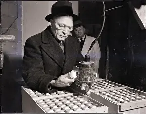 Examining Prints: Trader Looking Over Egg Shipment