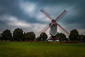 Windmill Gallery: Traditional wind mill in Lomel, Belgium, with clouds and grass field, long exposure