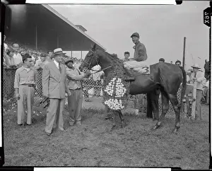 Trainer and Jockey with Horse in Winners Circle