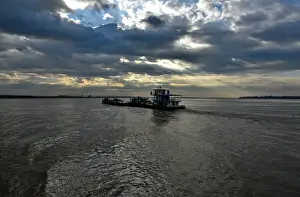Transport boat on Irrawaddy river at sunrise Myanmar Asia