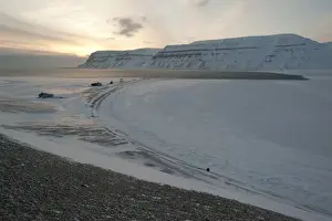 Svalbard, Norway Prints: Trapper huts at Cape Schoulz at sunset on the partially frozen Tempelfjorden