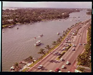 Travelers by Boats and Cars near Miami Hotel Site
