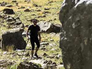 Risk Prints: Tripper with rucksack and stick crossing a way of high mountain in the pyrenees, Gavarnie