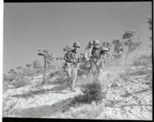 Troops Carrying a Victim over Terrain