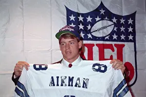Troy Aikman Holding Jersey