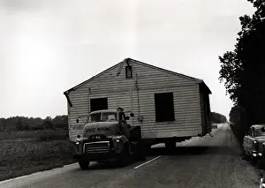 Truck Moving House down Road