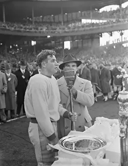Tuffy Leemans Standing at Microphone with Host of His Award Ceremony