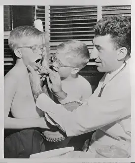 Twin Brothers Receiving Physical Exam from Doctor
