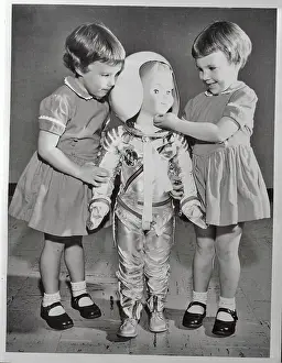 Twin Girls Playing with Astronaut Doll