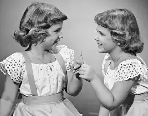 Twin sisters making a wish