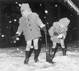 Snowfall Prints: Twins Playing in Snowstorm in New York City