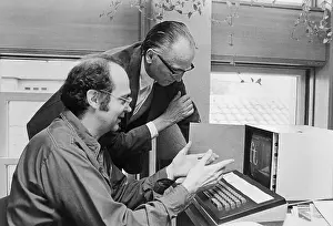 Typewriting Engineers Working on Machine