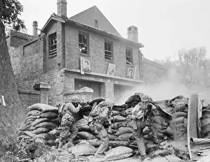 U. S. Soldiers Crouched in Front of Building
