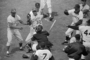 Umpire Holding Back Player Charging Pitcher with a Bat