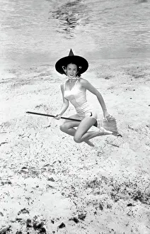 Underwater witch riding a broom