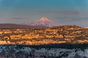 unique Rock formation of Goreme with Mount Erciyes background