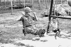 Cu Chi Prints: U.S. Soldier and Vietnamese Child on Swingset