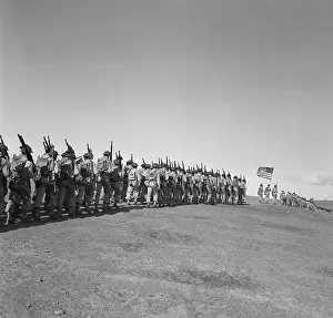 U.S. Troops Marching, Flag Held In Middle