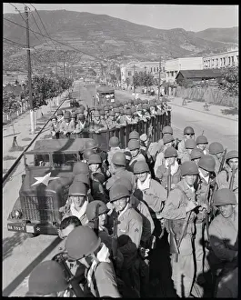 U.S. Troops Riding In Military Vehicles