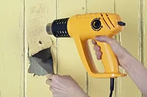 Wood Gallery: Using a heat gun and scraper to strip paint from a wooden surface