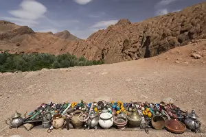 Morocco, North Africa Prints: Vendor displays souvenirs and trinkets on blanket alongside road, Dades Gorge, Morocco