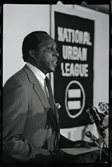 Vernon Jordan Standing by Banner