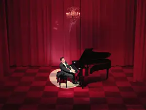 Victor Borge Performing on Stage with Piano