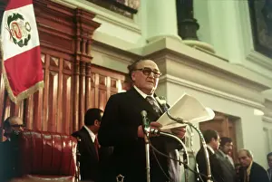 Victor Raul Haya De La Torre with Papers at Podium