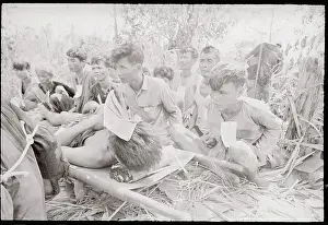 Viet Cong Captives Standing by Injured