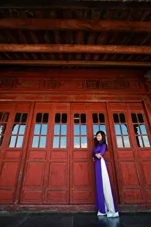 Images Dated 14th June 2016: Vietnam Ao Dai - Vietnamese woman in Ao Dai traditional dress near red doors
