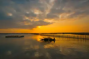Prints of Fisherman go fishing on boat near net system on Tam Giang lagoon, Hue, Thua Thien Hue, Vietnam, Asia Tran Tuan Viet's Vietnam Prints: Vietnam - Fisherman go fishing on boat near net system on Tam Giang lagoon