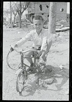 Vietnamese Boy on His Destroyed Bicycle
