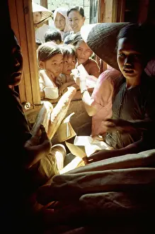 Vietnamese Children Crowded in a Huddle for Food